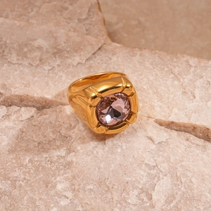 Macro shot of gold stainless steel ring with a purple square-cut zircon stone detail