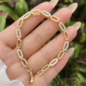 Elegant 18K gold plated bracelet with cubic zirconia oval links held in palm