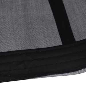 Macro shot of grey fabric texture and black twill binding with triple-line reinforcement