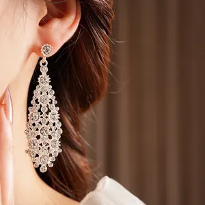 Luxury silver-tone irregular diamond-shaped dangle earrings with sparkling cubic zirconia
