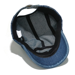 Interior detail of washed denim 5-panel cap showing care label and adjustable strap