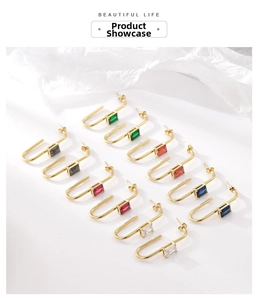 Detail view of U-shaped gold earrings set with rectangular zirconias in six colors