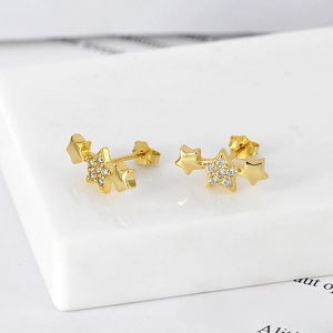 Macro view of gold S925 sterling silver star stud earrings with pavé cubic zirconia stones