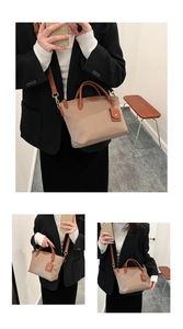 Detailed view of beige nylon tote bag with brown leather handles and matching pouch charm