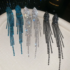 Detailed view of shimmering tassel earrings in teal, silver, and black rhinestone styles