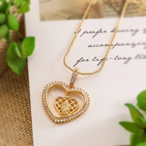 Gold double heart locket necklace with zircon inlay and Maria angel charm on script card