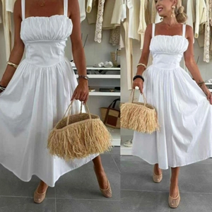 Detail of white cotton midi dress featuring elegant pleated bust design and high waist line
