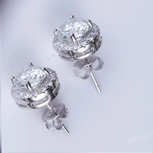 Macro shot of 925 sterling silver round halo stud earrings with four-prong setting