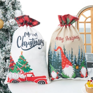 Close-up of Santa Claus drawstring gift bags on a festive white platform display