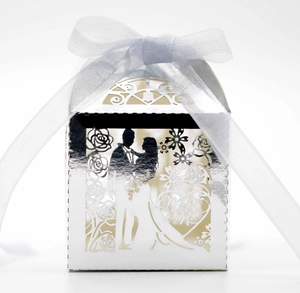 Detail of silver laser-cut wedding favor box with Mr & Mrs bride and groom silhouette