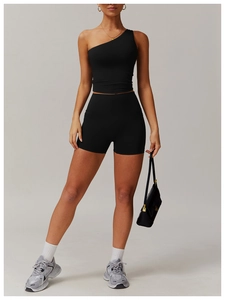 Détail d'un ensemble de yoga noir asymétrique montrant le tissu élastique gainant