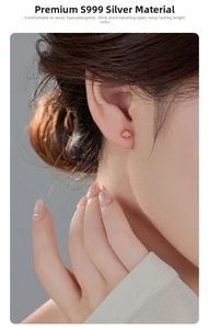 Close-up of S999 sterling silver stud earring with round orange gemstone on ear