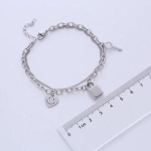 Silver double-layer titanium bracelet with heart smile, lock and key pendants size scale