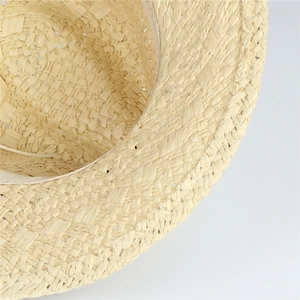 Close-up of the fine straw weave texture and inner sweatband on a beige sun hat