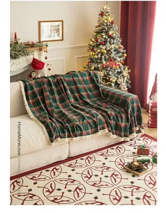 Detailed texture of Christmas plaid throw blanket with beige tassels on fabric sofa