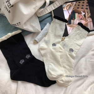 Detailed close-up of winter fleece socks featuring elegant camellia flower patterns