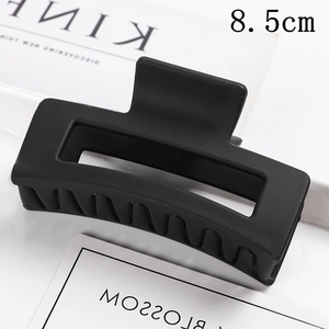 Detail view of an 8.5cm matte black rectangular hair claw clip with a non-slip design