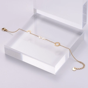 18k gold plated stainless steel bracelet with heart, moon and Greek key charms
