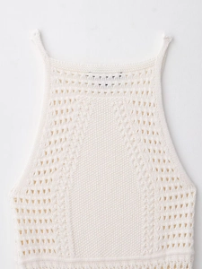 Detail shot of halter neck mini dress showing intricate hollow crochet knit texture