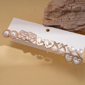 Ten-piece vintage gold earring set with faux pearls, floral designs, and rhinestones
