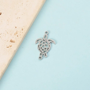 Macro view of silver hollow turtle pendant with double holes and fine carving detail