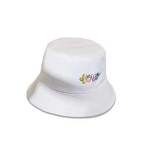 Detailed close-up of white bucket hat with colorful LOVE embroidery and pink Minnie bow