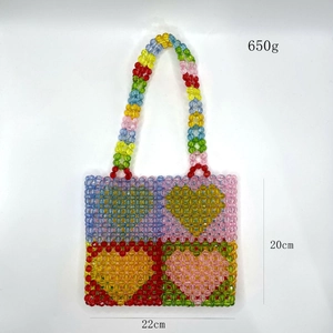 Detail view of colorful beaded tote bag with heart patterns and dimensions 22x20cm