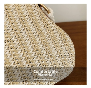Detail of high-density straw weave texture with gold metal ring and white rope handle