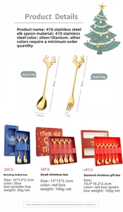 Detail of deer-shaped stainless steel spoons and forks in gold and silver gift boxes