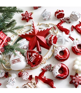 Flat lay of red and white Christmas ornaments including star, house, and donut shapes