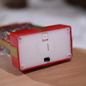 Detail view of the Christmas night light base with battery compartment and power switch