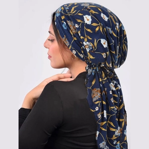 Detail of navy blue floral turban showing elegant fabric texture and long ties for women