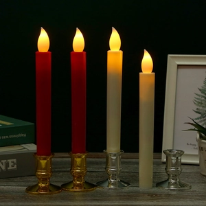 Close-up of LED taper candles with golden bases showing realistic flickering warm flame
