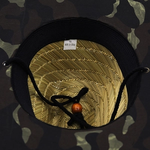 Interior view of camo outdoor sun hat featuring woven straw texture and adjustable strap