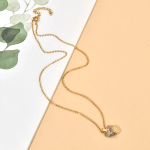 Detail of gold heart pendant with colorful zircon and adjustable extension chain