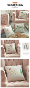 Detail of white velvet Christmas cushion covers with gold foil trees and festive lettering