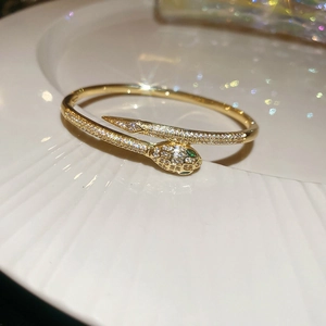 Macro shot of snake bracelet with 18k gold plating and shimmering cubic zirconia stones