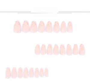 Detail view of 24 pieces almond press on nails with gold star patterns on pink base