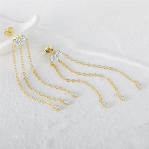 Close-up of S925 sterling silver gold earrings with marquise zircon and tassels