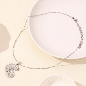 Detail of silver chameleon lizard pendant necklace with polished scale texture and chain