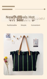 Detail of woven beach tote with colorful stripes, bohemian fringe, and leather handles