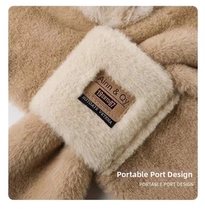 Close-up of the plush crossover scarf featuring portable port design and leather label