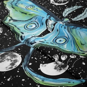 Detail of hanging tapestry showing teal moth design and celestial moon phases on fabric
