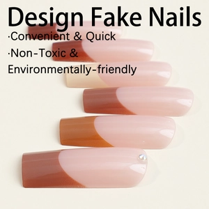 French coffee and pink coffin press-on nails with sparkling rhinestones on beige surface
