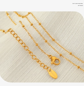 Detail der 18K vergoldeten Edelstahl-Kugelkette mit Karabinerverschluss und Verlängerung