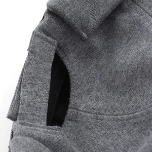 Close-up of adjustable velcro strap and ponytail hole on gray knit cotton skull cap