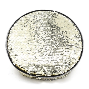 Detailed close-up of a round flat coin purse with gold and silver sequins and black zipper