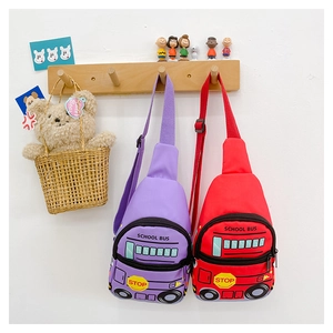 Red and purple school bus shaped kids chest bags hanging on wooden wall hooks