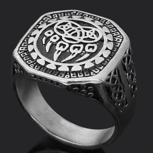 Macro shot of silver Viking ring with bear paw engraving and Celtic knots