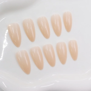 Glossy translucent pink almond press-on nails set of 10 pieces on white tray